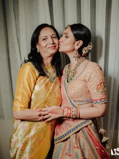 A tender kiss from mother to daughter. This portrait of Shristi and her mom is full of warmth and affection, a timeless image of maternal love.