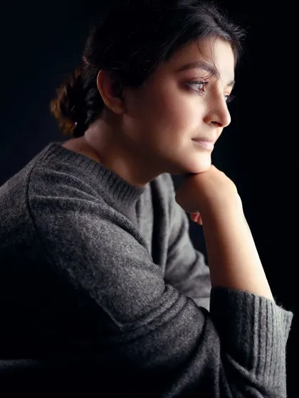 A profile portrait from the same series, demonstrating a different angle. The lighting sculpts her features, highlighting the jawline and creating a thoughtful, classic look.