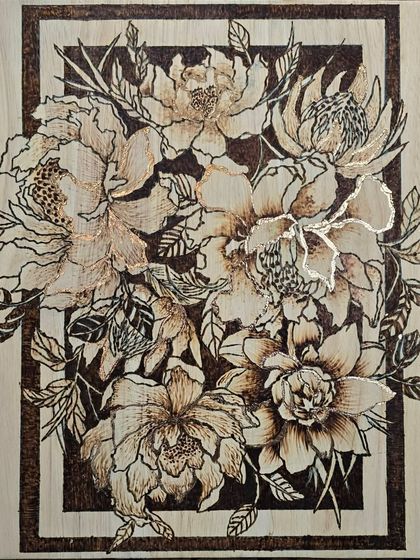 In this pyrography piece, I combined wood burning with gold foiling to create a beautiful floral design. The gold adds a touch of light and elegance to the rustic feel of the burned wood.
