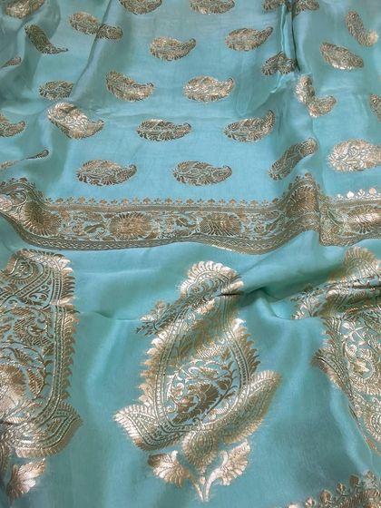 A lovely pastel blue Banarasi saree with delicate paisley butis woven in gold. This saree is a wonderful example of how traditional weaves can also be light, airy, and perfect for daytime functions.