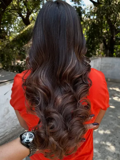 A simple highlight refresh can make a world of difference. I brightened up her existing color and gave her a fresh style, making her hair look vibrant and healthy again.