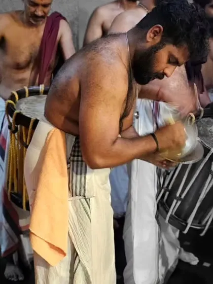 An Ilathalam artist captured in a moment of reverence and focus during the Mandala Masam festival performance.
