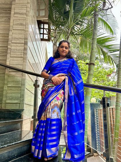 A happy client looking beautiful in her blue and white pure Mysore crepe digital print saree.