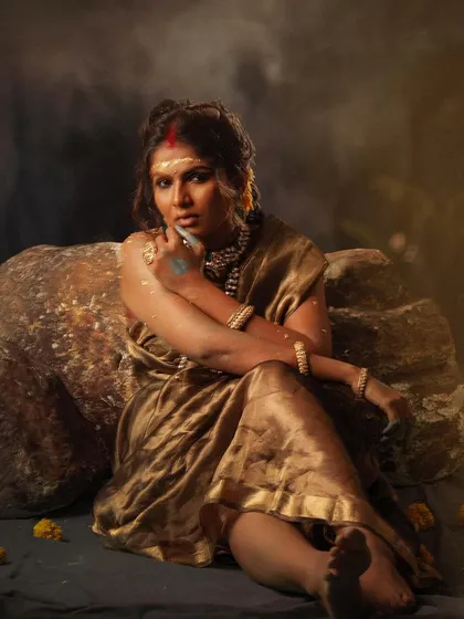 A full-body shot from the "सुवर्ण कांता" series, showcasing the unconventional drape of the saree and the raw, powerful pose.