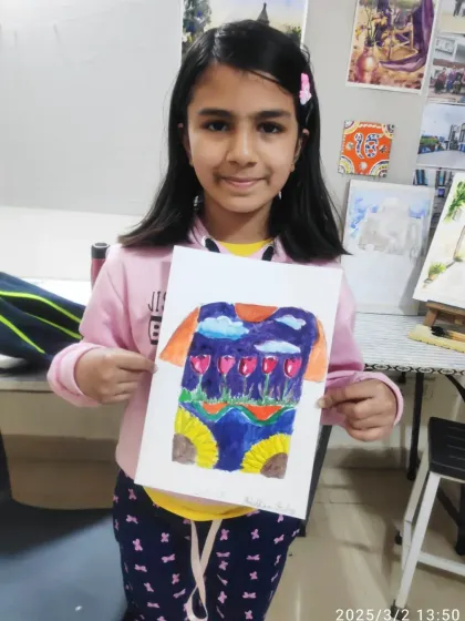 Aneeskha from our Prathamik Part 1 course with her imaginative T-shirt design. She created a landscape with tulips under a cloudy sky.
