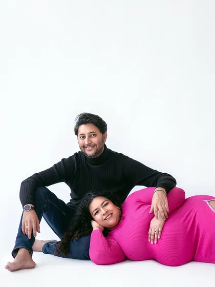 A relaxed and intimate pose, with the mother-to-be resting comfortably, showcasing a beautiful moment of peace and connection.
