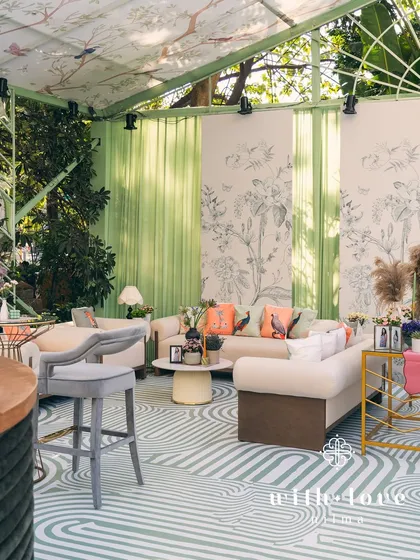 A serene and modern baby shower designed as a chic conservatory. Featuring custom botanical print walls, sage green accents, and contemporary furniture, this setup creates a light-filled, elegant space for celebration.