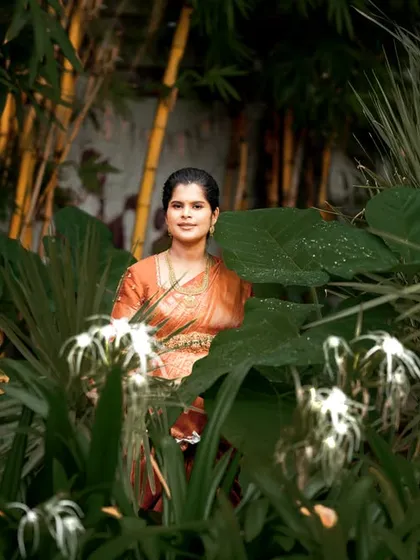 Using nature as a frame, we captured this beautiful solo portrait of the mom-to-be. The lush green foliage provides a stunning, natural backdrop for her traditional attire.