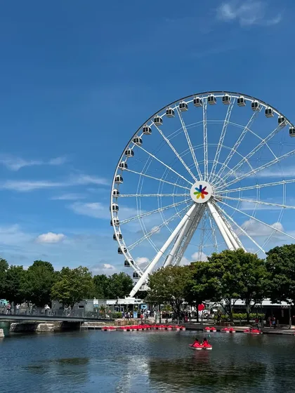 A bright, sunny day at the Old Port in Montréal, with the La Grande Roue de Montréal ferris wheel. This is a classic, high-quality travel shot.