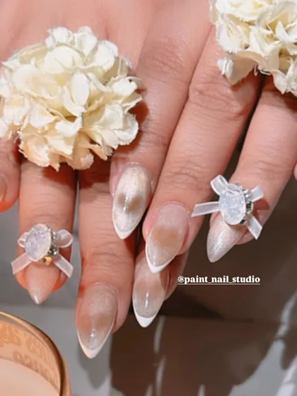 A final shot of the date night nails, complete with 3D bows, flowers, and a lit candle for the perfect ambiance.