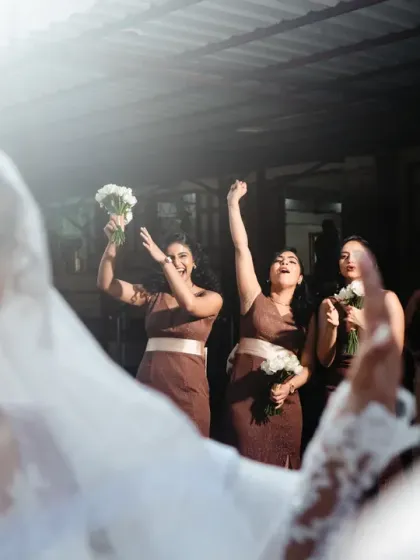 The bridesmaids cheer as they see the bride, a shot taken from the groom's perspective.