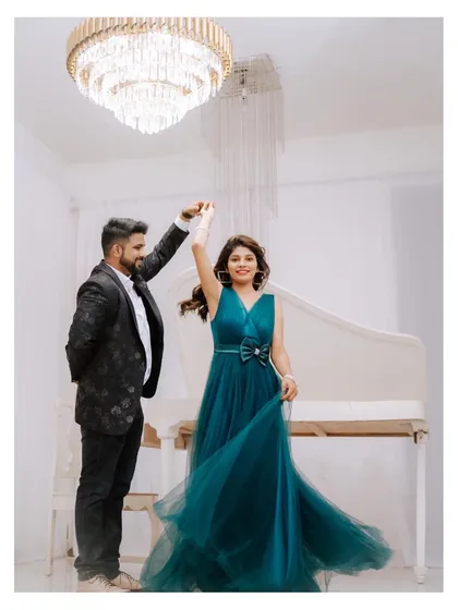 The pure joy of a dance. This photo captures the bride's happiness as her partner twirls her in a beautiful studio setting, creating a classic and elegant pre-wedding memory.