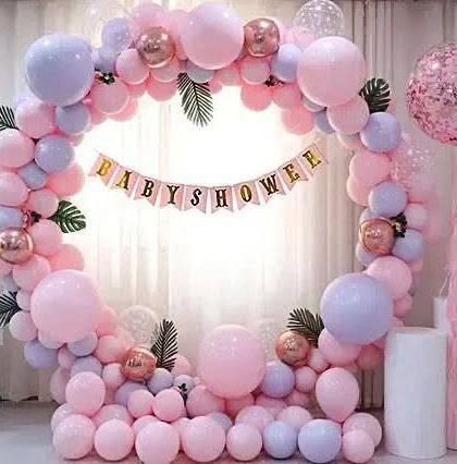 A beautiful pastel pink and purple balloon ring for a baby shower, with a "BABY SHOWER" banner.
