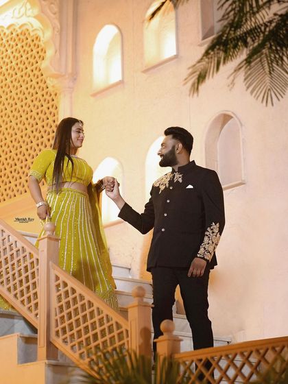 An elegant evening look for a pre-wedding shoot. The makeup is glamorous, with a focus on highlighting her features against the beautiful night-time architecture.