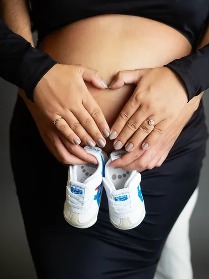 Sometimes, the smallest details tell the biggest story. This classic shot with tiny baby shoes held over the bump is a sweet and simple way to announce your joy and the new journey you are about to begin together.