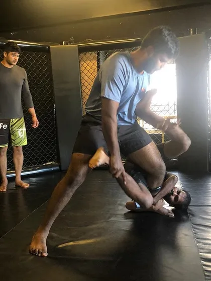 This is a great action shot from one of our BJJ Jams. It shows a student working to pass the guard, a fundamental skill in Brazilian Jiu-Jitsu for getting into a dominant position.