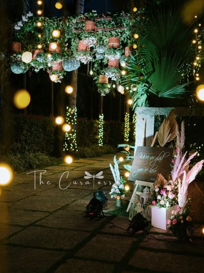The entrance pathway illuminated by hundreds of tiny lights, creating a bokeh effect that adds a touch of dreamlike magic to the evening.