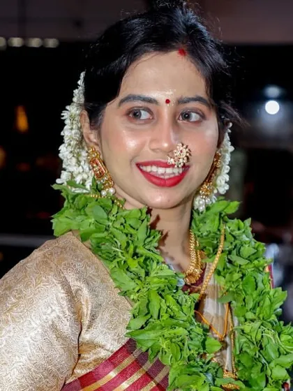 The happy smile of a bride on her wedding day. Her traditional Kerala saree, which I had the honor of draping, looks radiant during her morning temple ceremony.