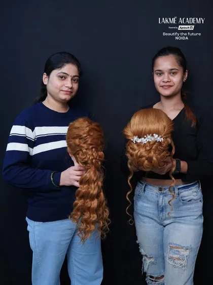 Students showcasing their half-up, half-down and open-hair styling work on mannequins.