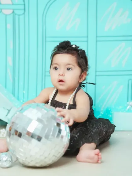 This little fashionista is playing with a disco ball prop in our custom 'Tiffany & Co.' setup.