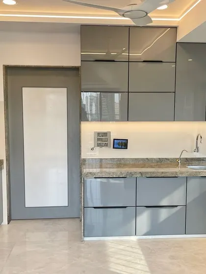 A full view of the C-shaped kitchen in Monoton English Grey, showcasing the harmonious and modern design.