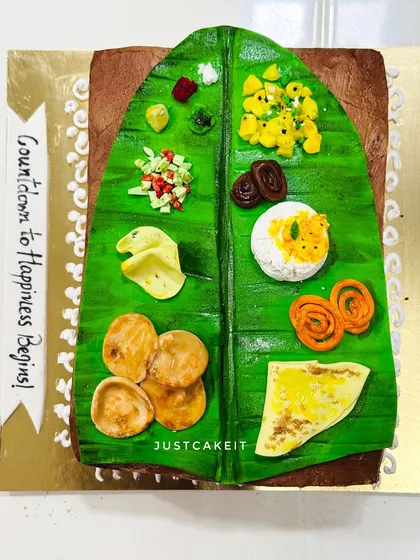 A 'Kelvan' theme cake, designed to look like a traditional Maharashtrian feast served on a banana leaf. All the food items are hand-molded and edible.