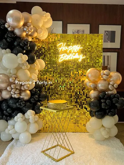 A straight-on shot of the glamorous gold sequin birthday setup. The combination of the shimmering wall and the modern neon sign creates a vibrant and celebratory feel, perfect for photos.
