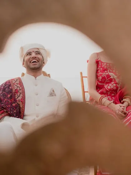 The groom's joyful laugh during the wedding rituals. We strive to create a lighthearted and happy atmosphere for everyone involved.