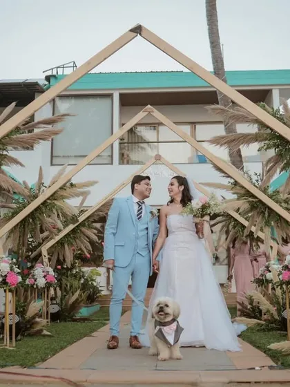 Your family includes your furry friends too. We were so happy to capture this beautiful moment with the couple and their dog at their serene beachside wedding, creating a truly complete family portrait under a gorgeous floral arch.