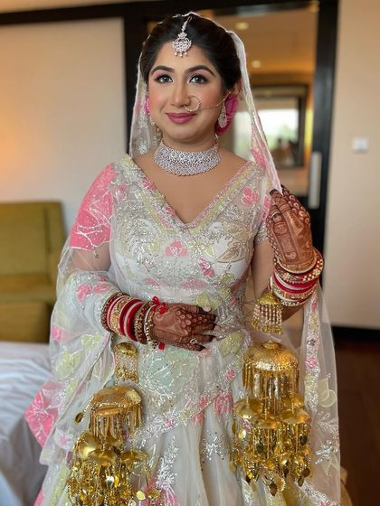 A full-length view of the bride, looking absolutely stunning in her floral lehenga.