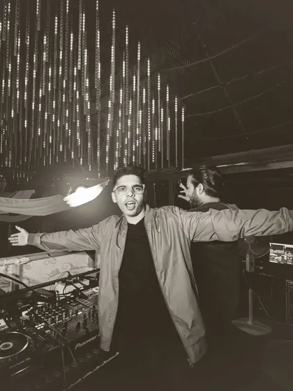 A classic black and white shot, arms open wide, embracing the new year and the crowd.