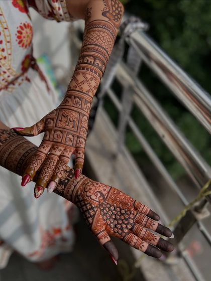 A different angle of the back-of-hand design, showing the peacock and elephant details.