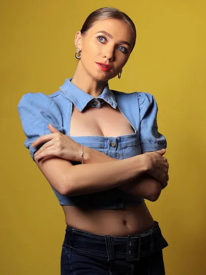 A tilted, dynamic pose that adds a playful element to the denim portrait.