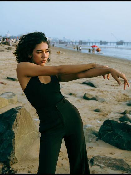 An expressive pose with dynamic arm movements. This shot captures the model's ability to create interesting shapes and convey emotion.