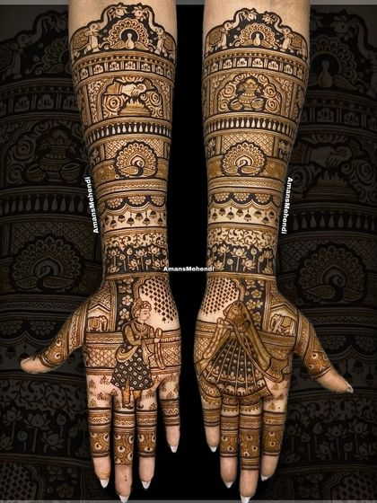 A luxurious and bespoke bridal design. The palms feature portraits of a dancing bride and groom, surrounded by auspicious symbols like the kalash, hastmelap, and agni, all framed by elephants and peacocks.