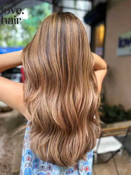 A detailed back view of the burnished bronde, highlighting the expert placement of the lighter pieces.