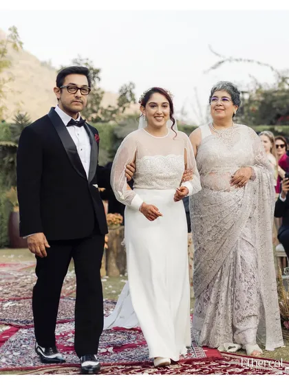 The bride being walked down the aisle by both her mother and father. This image is a powerful representation of family, support, and the beginning of a new chapter.