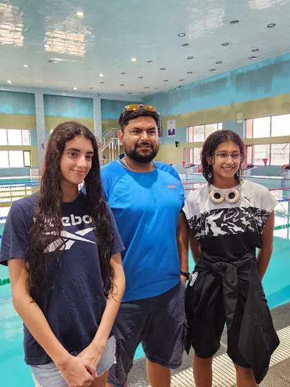 With my two champions, Veera and Prapti, at the SGFI State Championship. Sending two swimmers and having both return with top honors is a testament to our focused training program.