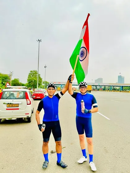 Two members holding the flag together, a symbol of our shared patriotism and friendship.