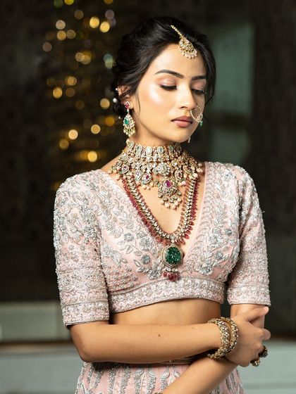 Twirl into a fairytale with this baby pink bridal lehenga. I designed it with intricate horse embroidery on the raw silk skirt and paired it with a heavily handworked blouse and a delicate net dupatta for a truly heavenly look.