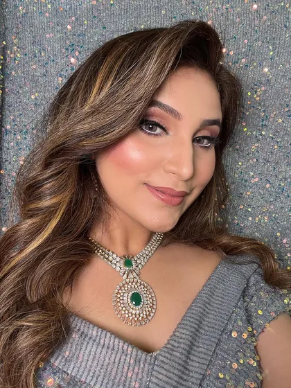 A final shot of the client's glamorous look. The combination of soft waves and a smokey eye is a timeless choice for any evening party.