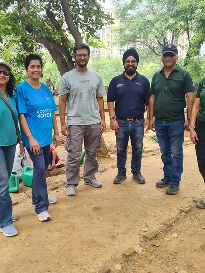 The core team and volunteers from NTT DATA stand together after a successful plantation drive at the Sector 56 creek, a vital water channel for Gurgaon.