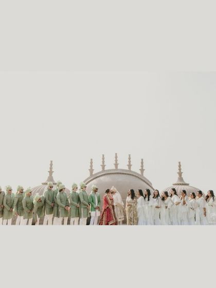 A wide shot of the couple and their wedding party, creating a beautiful, symmetrical line of color and celebration. This image captures the scale and joy of their big day.