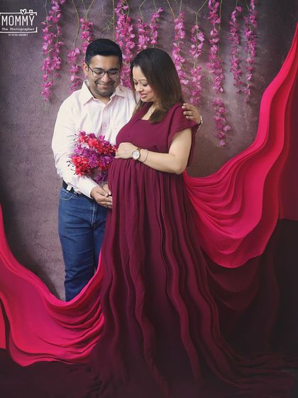 A loving look between the parents-to-be, surrounded by flowing fabrics. This studio couple's portrait is full of warmth and excitement for their new arrival.