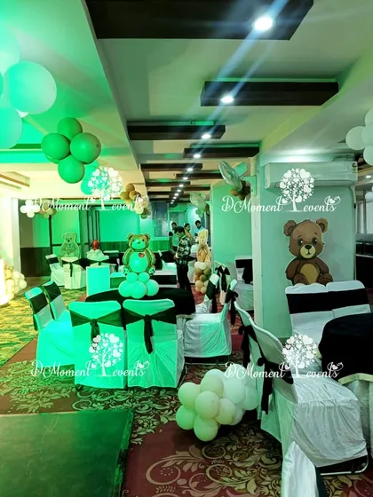 Thematic decor extending to the guest seating area. Chairs are decorated with sashes, and tables feature teddy bear balloon centerpieces, ensuring a cohesive look.