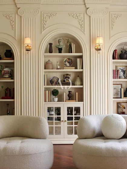 The full view of this Parisian-inspired lounge area, where modern, comfortable seating is set against a backdrop of exquisite classical architecture. It is a space designed for stylish relaxation.