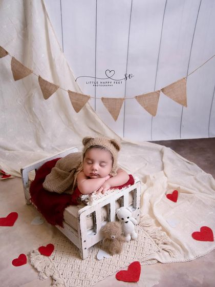 This little Romeo is ready to steal hearts. The Valentine's theme, with a bed of hearts and a cozy red blanket, is perfect for a February baby.
