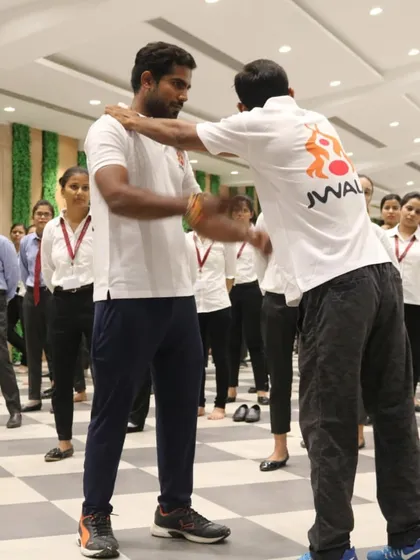 Demonstrating a technique to break an opponent's posture during a college self-defense workshop.