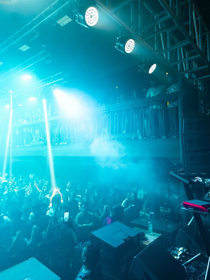 A view of the multi-level club during a live performance, showing a packed upper deck. I utilize every part of a venue to maximize capacity and create a dynamic, layered experience.