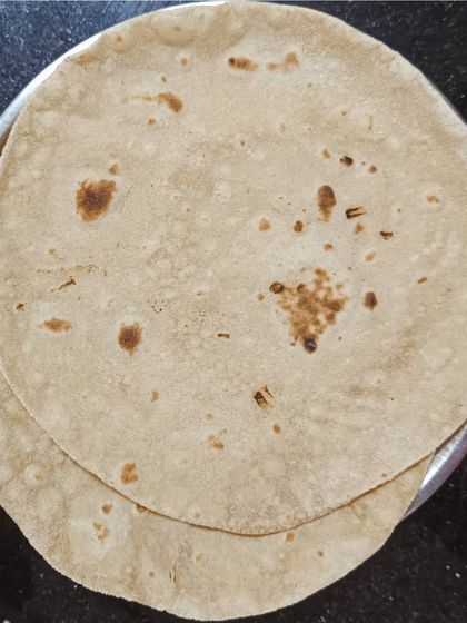 A plate of soft, warm chapatis, freshly made and ready to be packed. They are the perfect accompaniment to any of my curries.